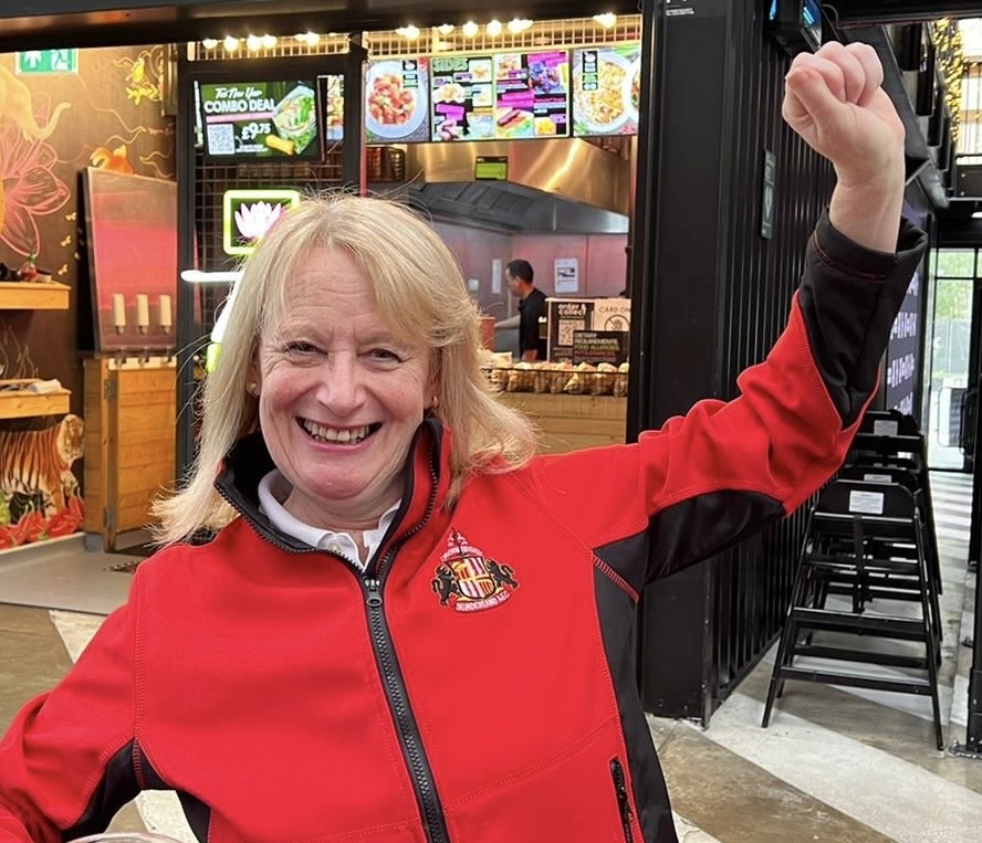 Christine Vasey in a red jacket.