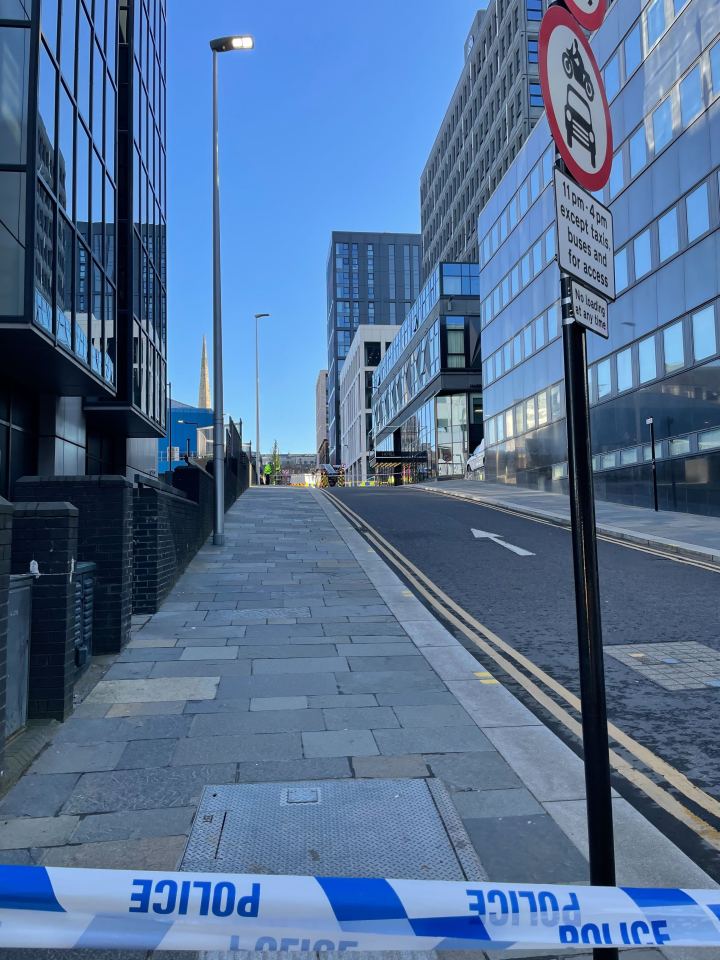 Police tape sealing off a street in Glasgow near a hotel.