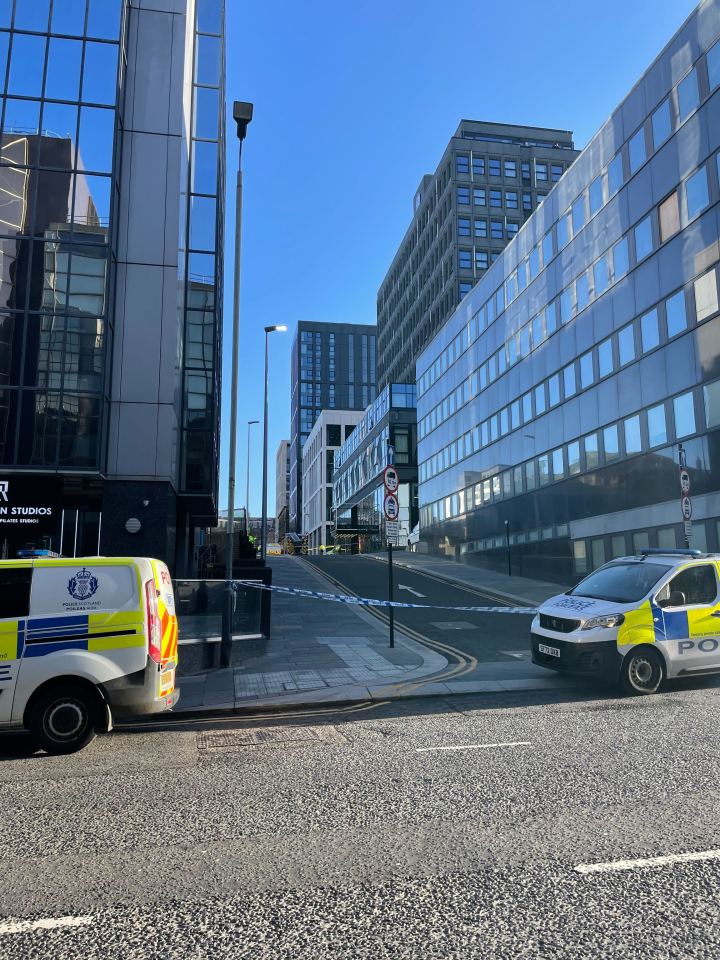 Police cars and crime scene tape in front of a hotel in Glasgow.