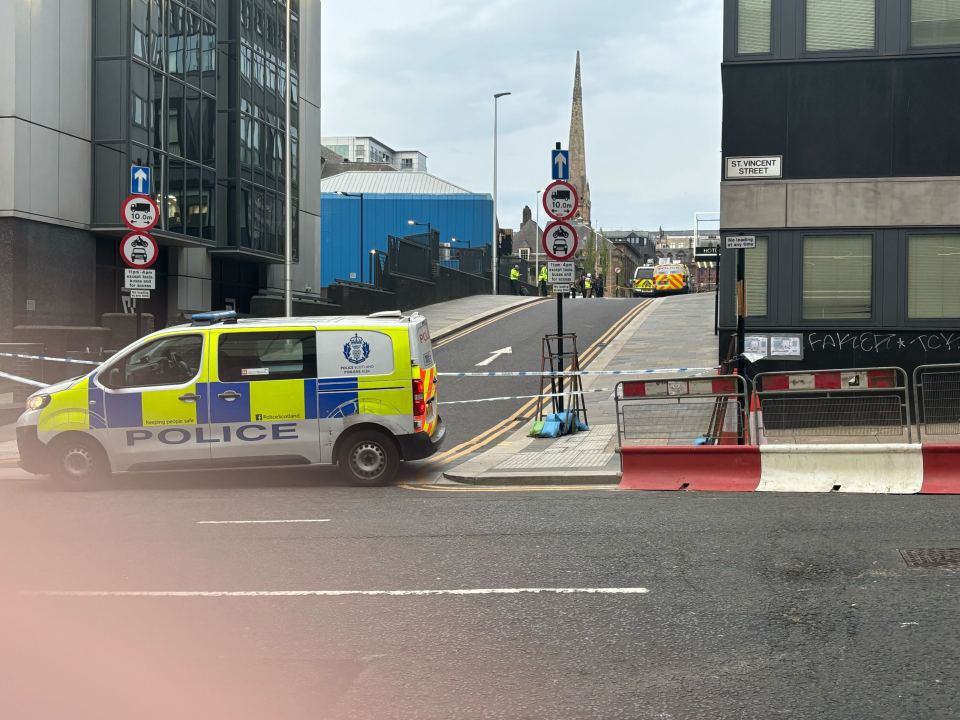 Police van and crime scene tape at a Glasgow hotel.
