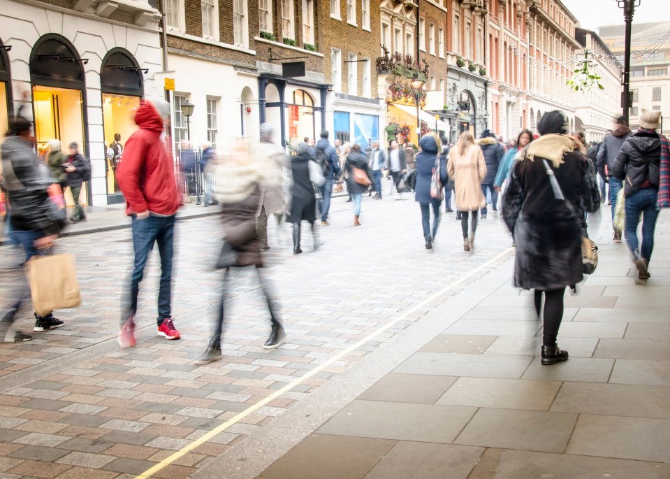 Motion-blurred photo of a busy London shopping street.