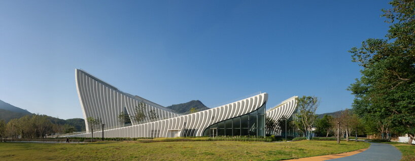 curved concrete roofs root atelier alter architects' museum into chinese mountain foothills