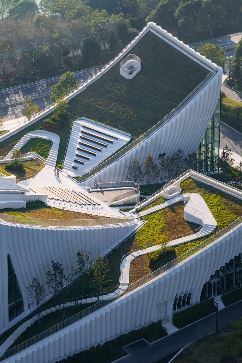 curved concrete roofs root atelier alter architects' museum into chinese mountain foothills