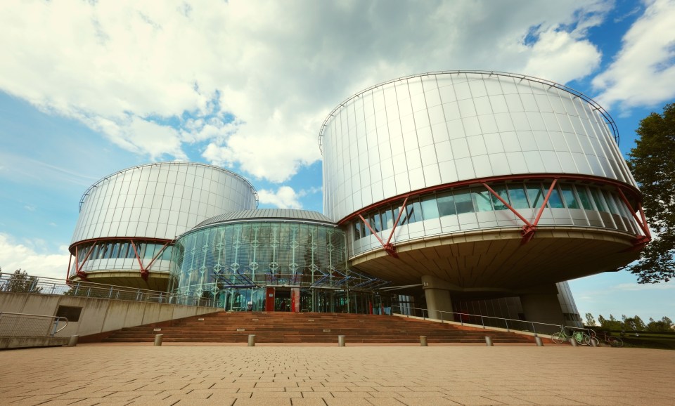 a large building with a blue sky in the background
