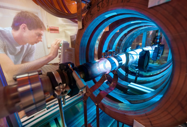 A researcher works on the AWAKE helicon plasma cell in a R&D laboratory at CERN.