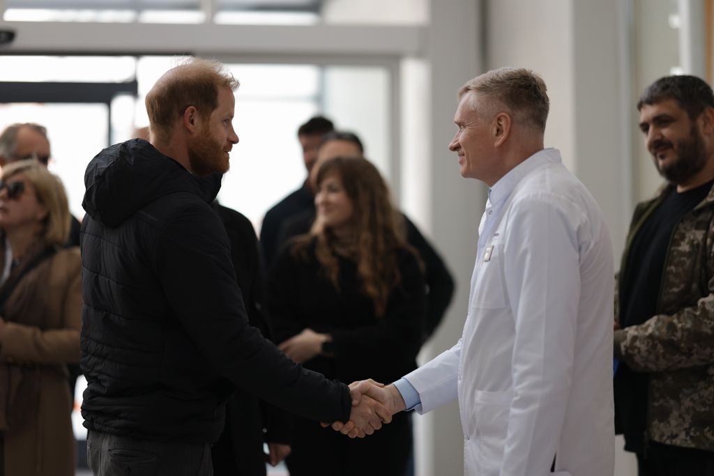 Prince Harry shaking hands with a doctor