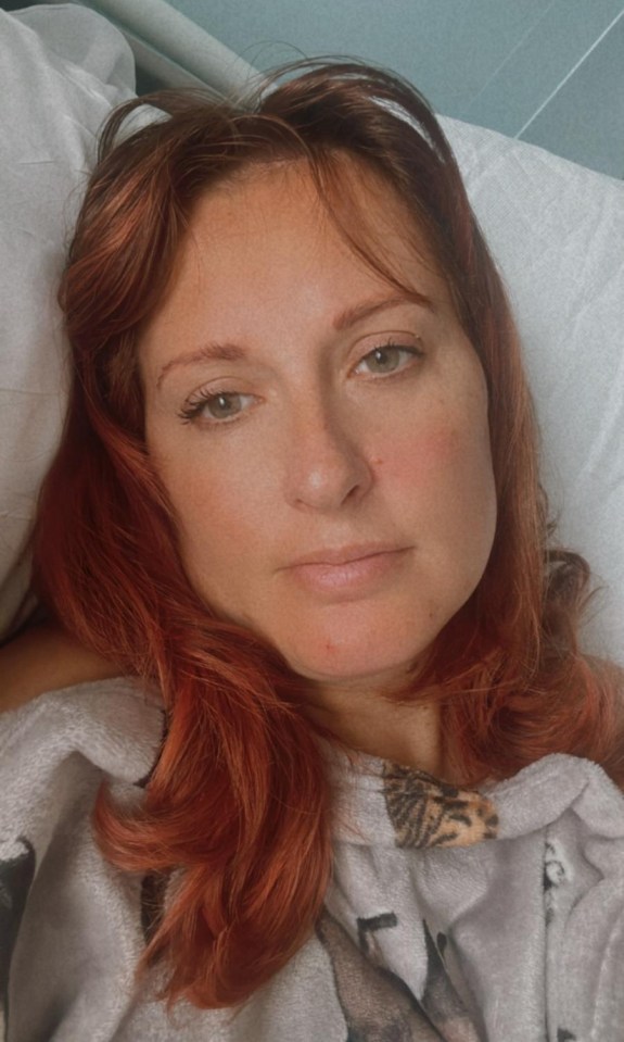 Woman with red hair lying in bed.