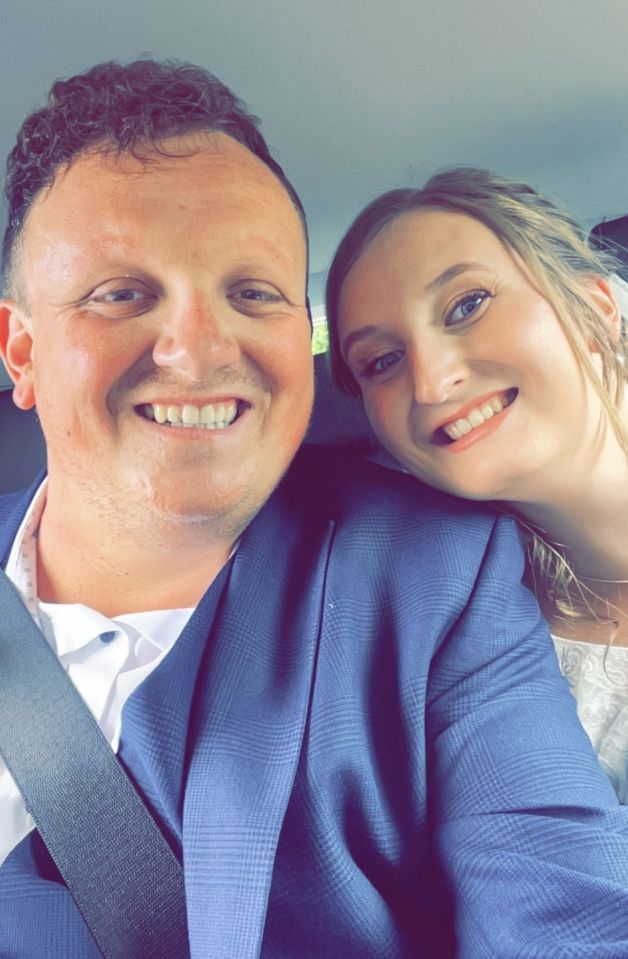 Photo of a man and woman smiling for a selfie.