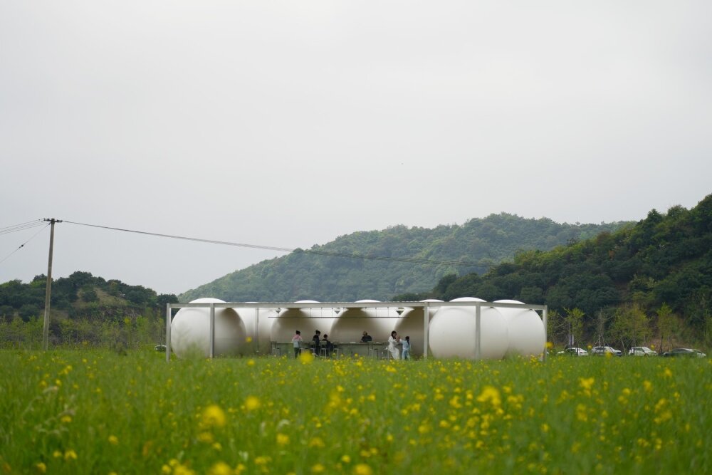 trio of inflated pavilions create rural café, cinema, and library amid rice fields in china