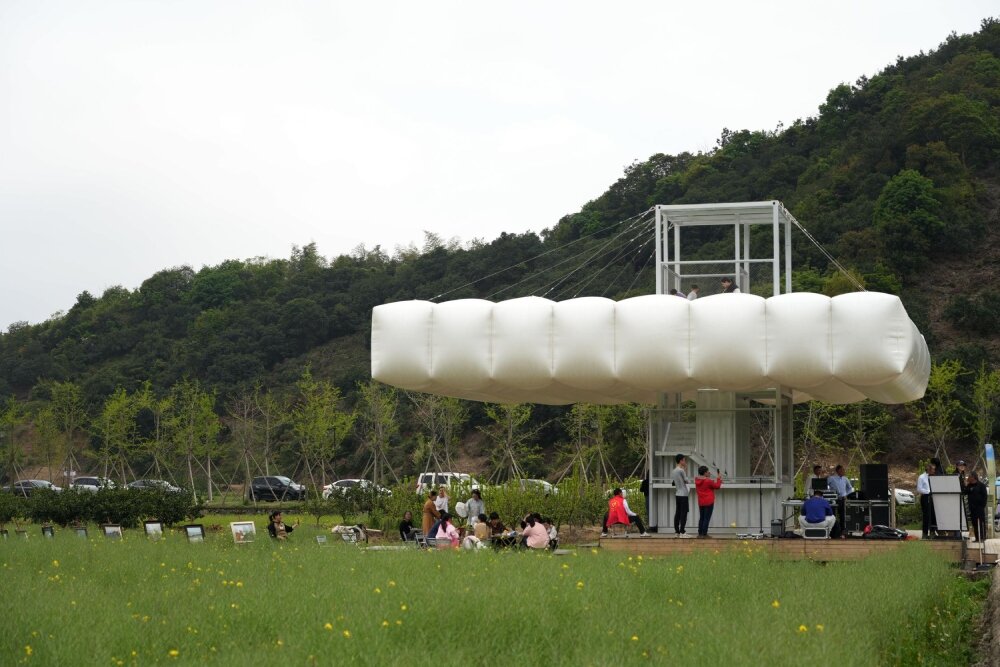 trio of inflated pavilions create rural café, cinema, and library amid rice fields in china