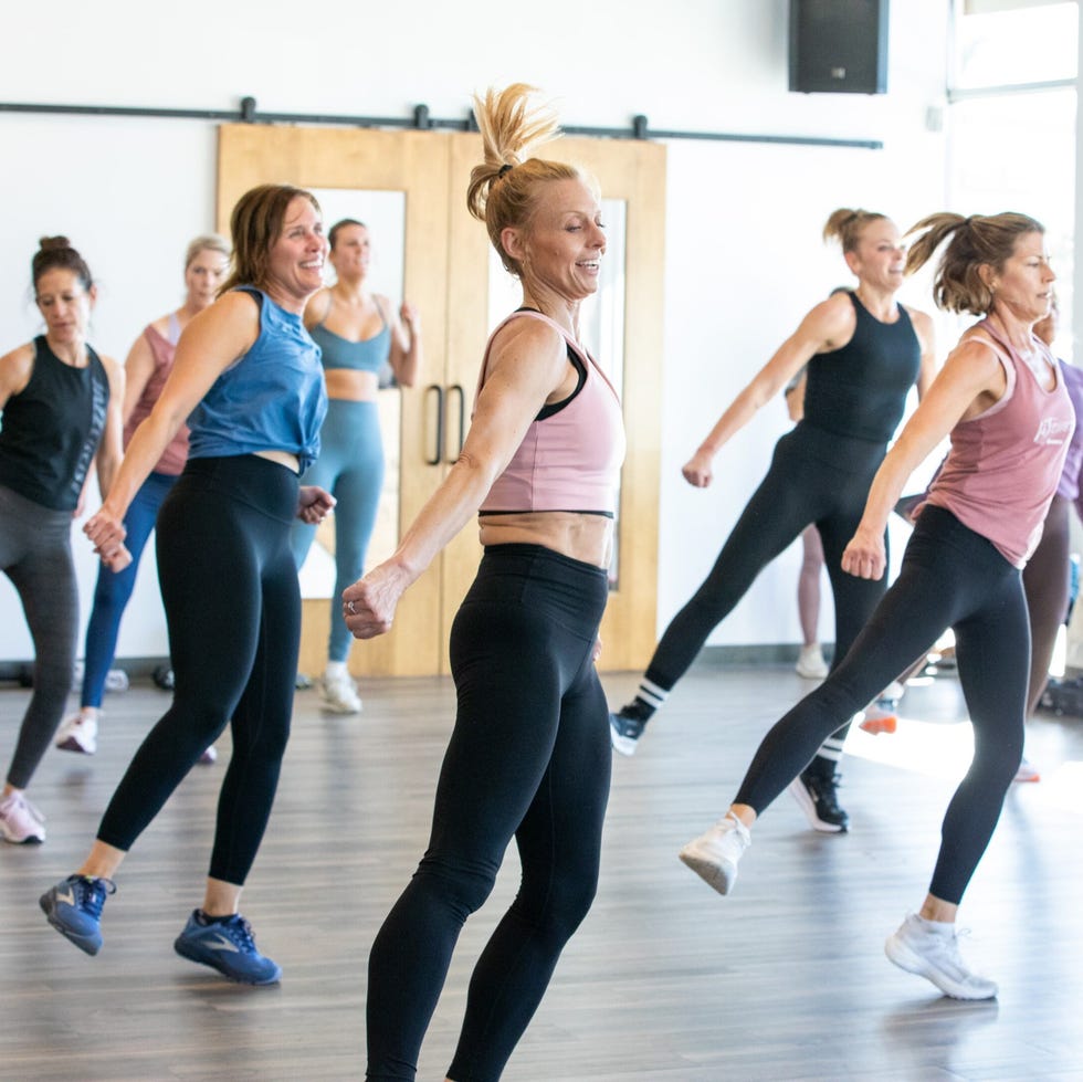 group exercise class with participants actively engaged in a workout