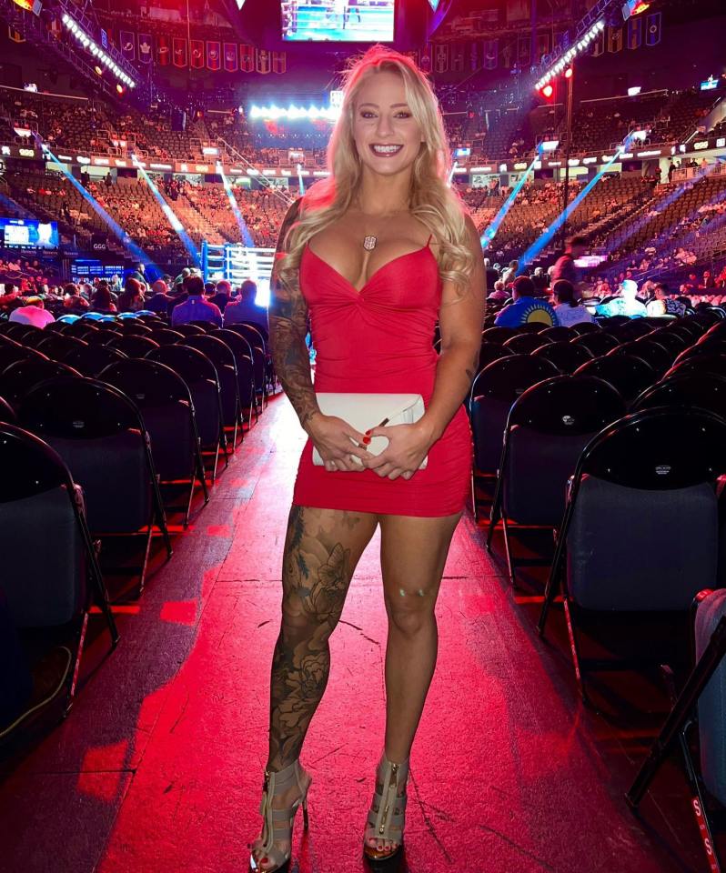 Woman in red dress at boxing match.
