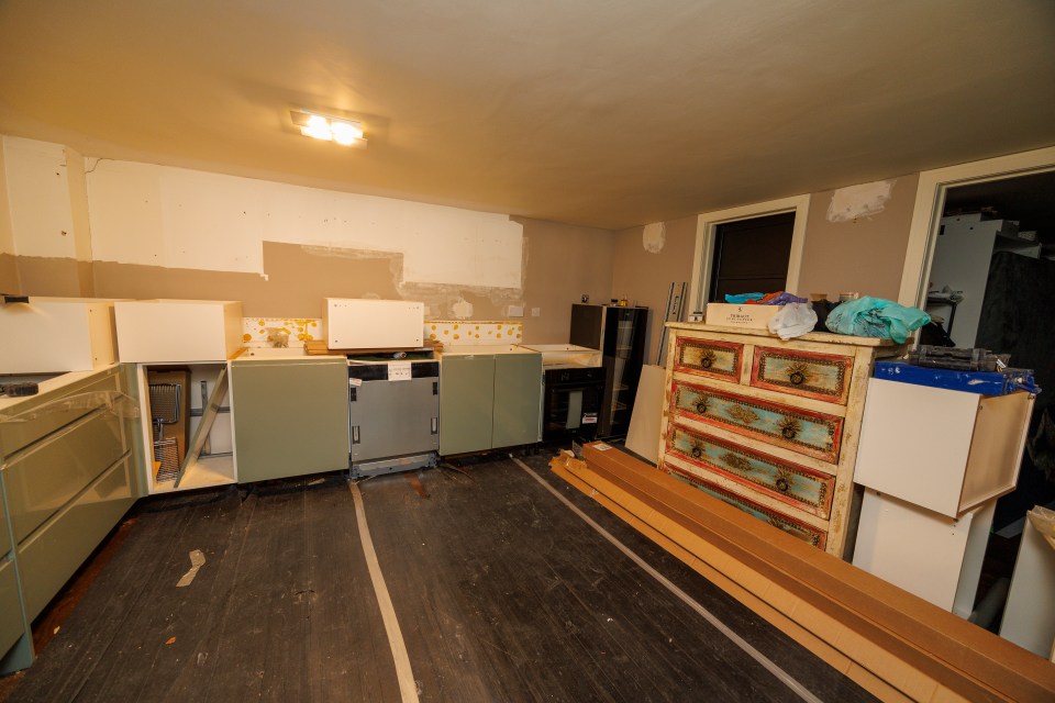 Unfinished kitchen with installed cabinets and appliances.