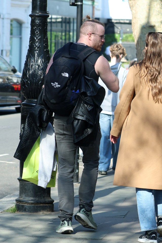 Robert Kazinsky walking down the street.