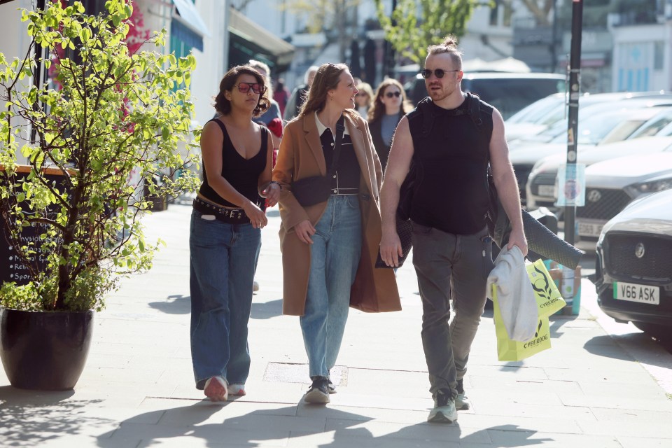 Robert Kazinsky walking with two friends.