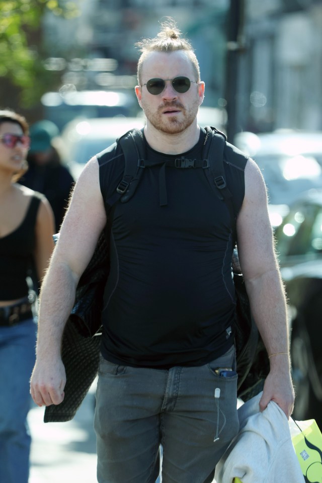 Robert Kazinsky walking down the street.