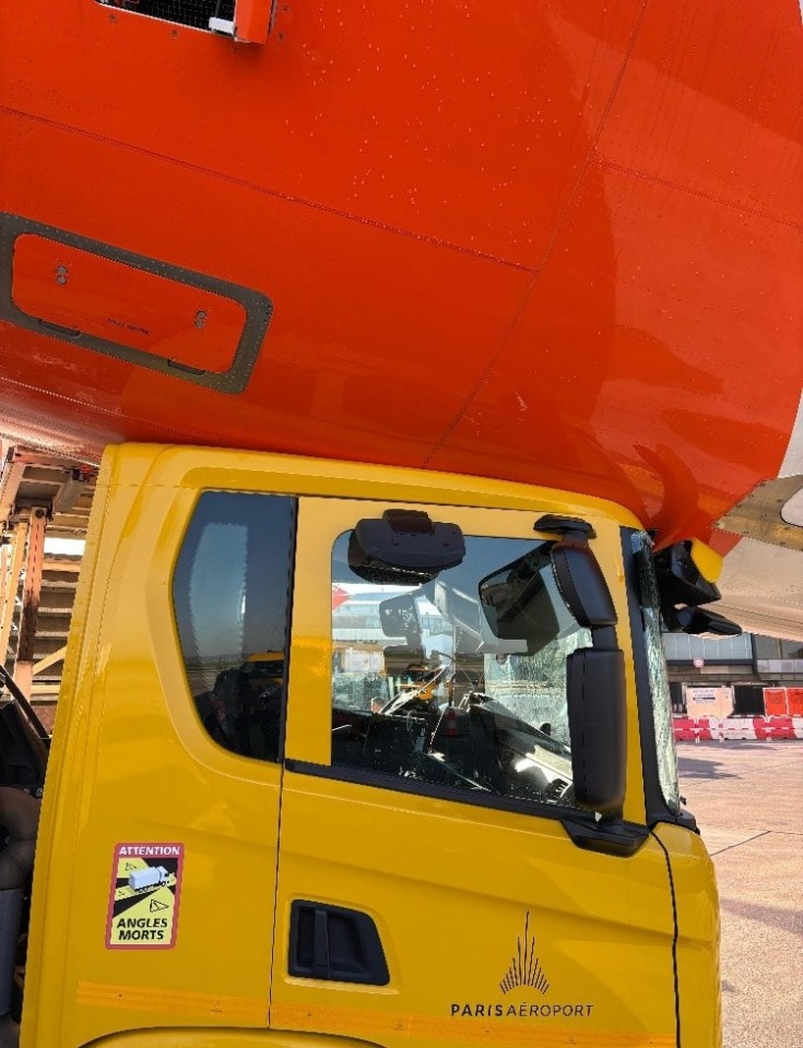 A yellow truck collided with an orange airplane.