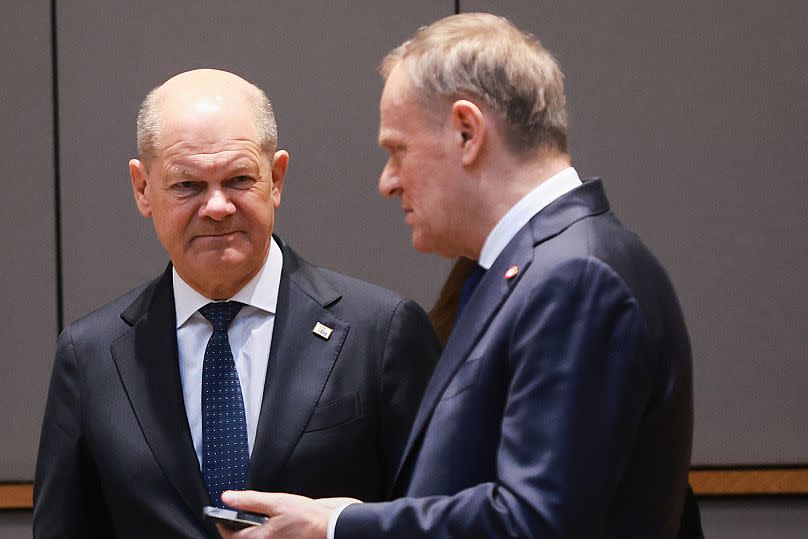 Germany's Chancellor Olaf Scholz, left, speaks with Poland's Prime Minister Donald Tusk during a meeting at an EU summit in Brussels, 20 March, 2025
