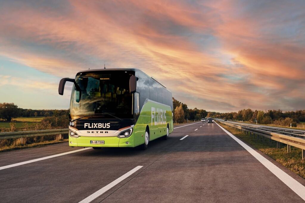 flixbus travelling down motorway with sunset in background