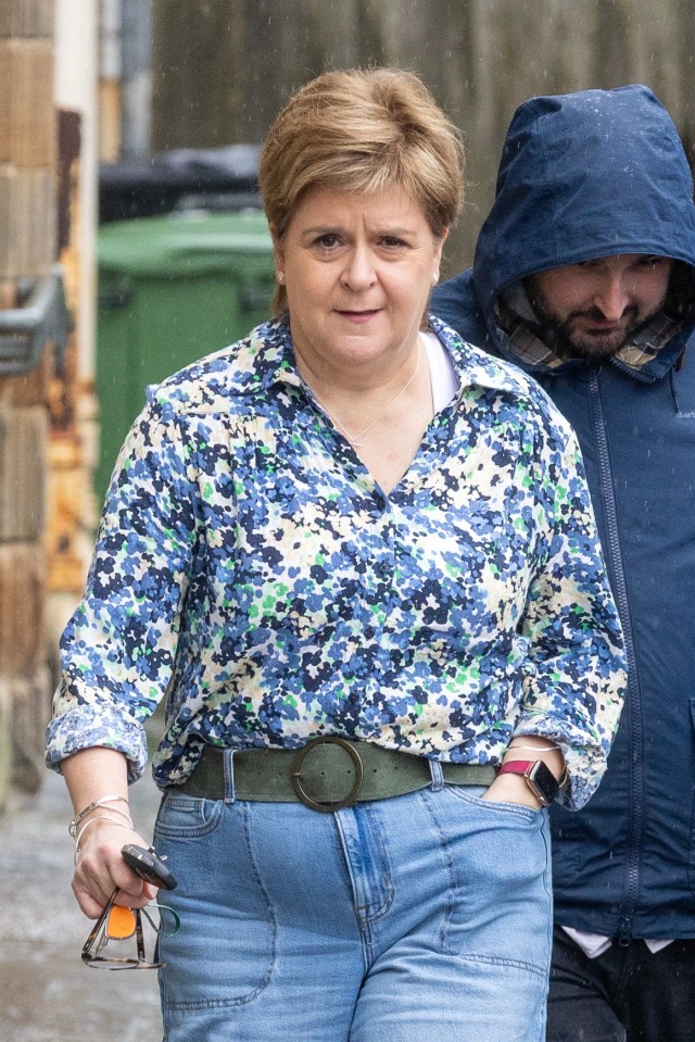 Nicola Sturgeon walking down the street.