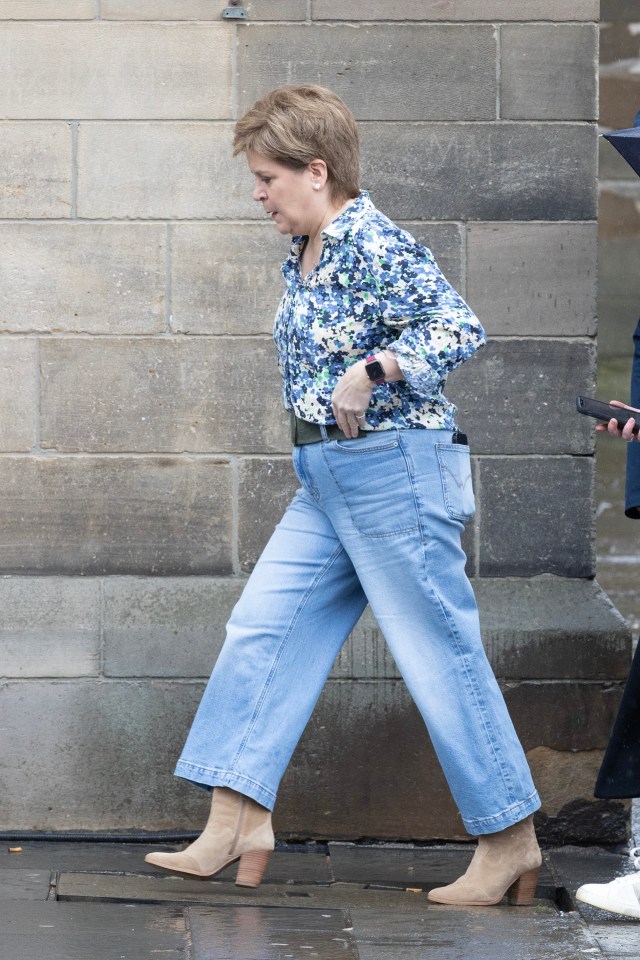 Nicola Sturgeon walking down the street.