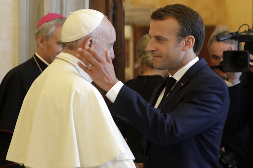 Emmanuel Macron greeting Pope Francis.