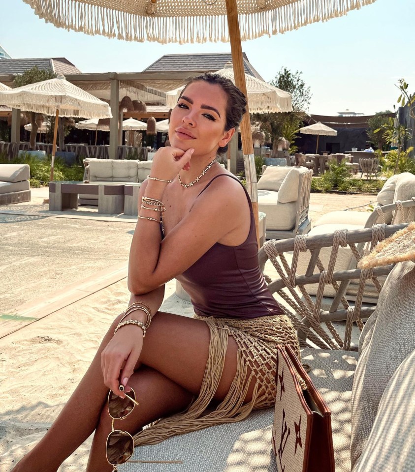 Gemma Owen in a swimsuit at a beach resort.