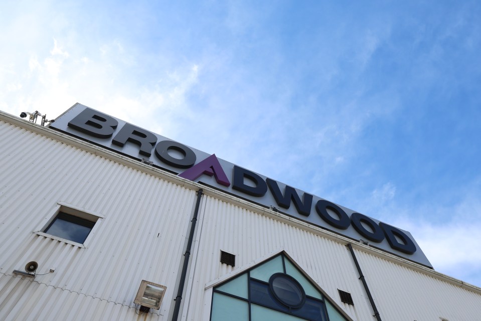 Broadwood Stadium sign against a blue sky.