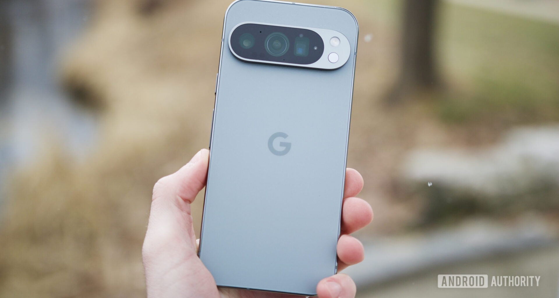 Someone holding the Google Pixel 9 Pro outside.