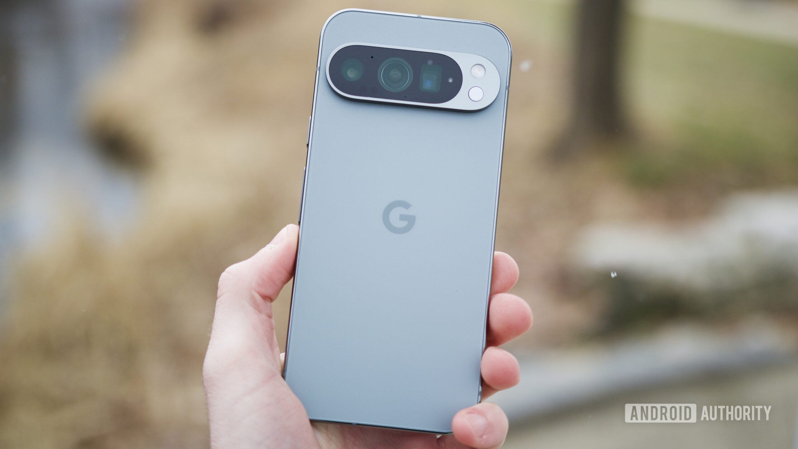 Someone holding the Google Pixel 9 Pro outside.