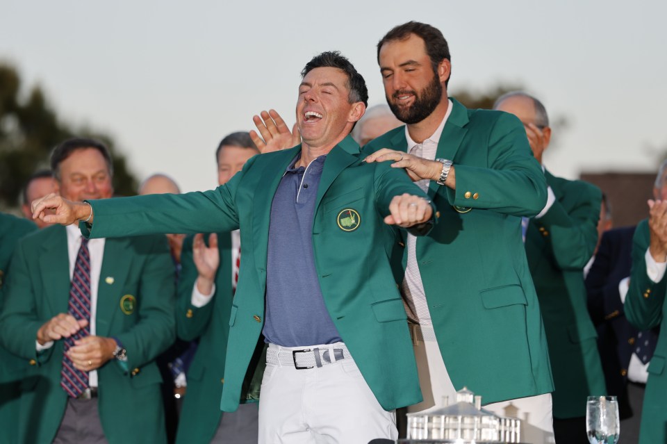 Rory McIlroy receiving his Masters jacket from Scottie Scheffler.