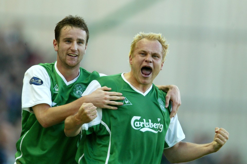 Two Hibernian football players celebrating a goal.