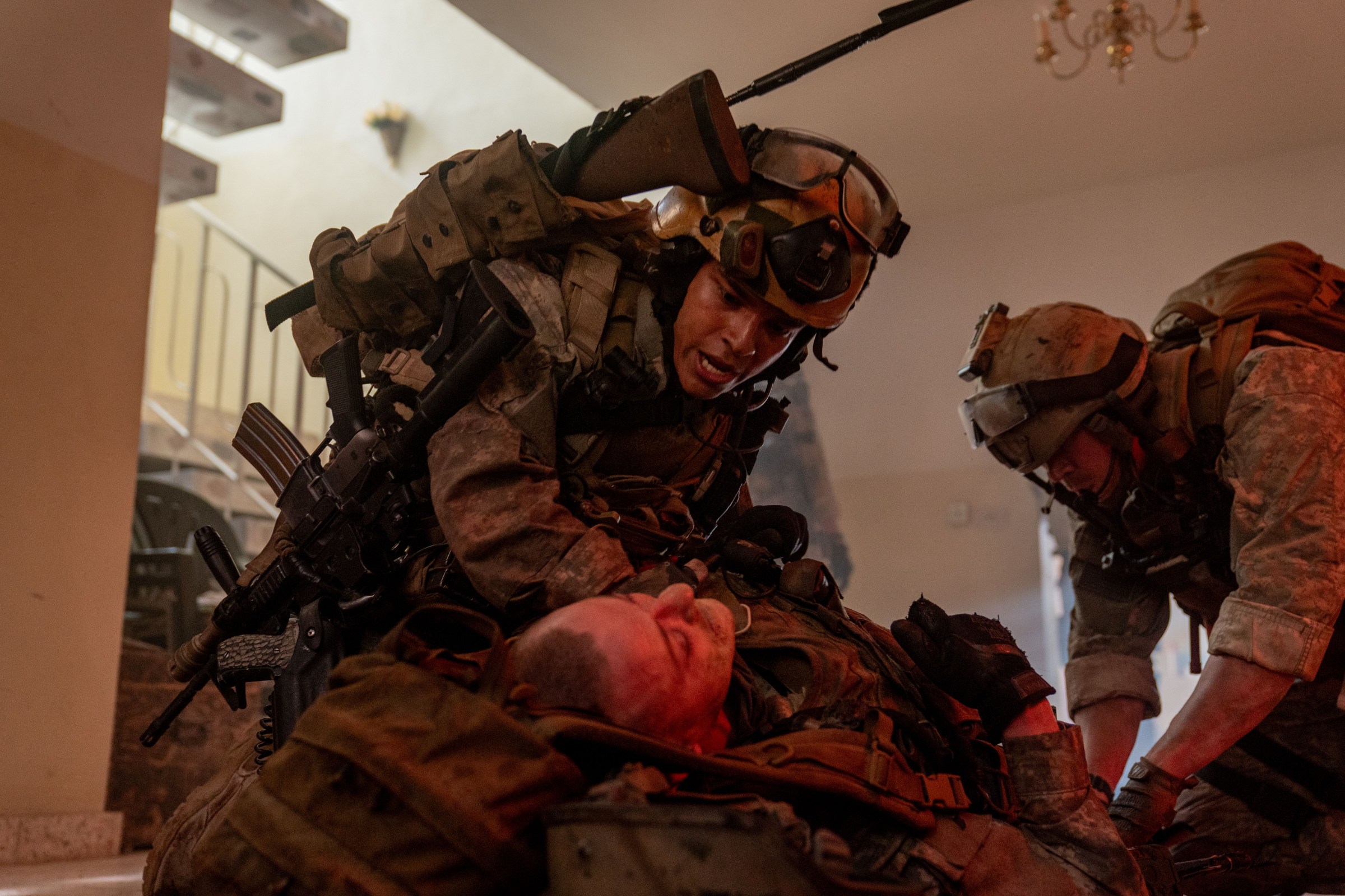 Will Poulter kneels over an injured squadmate in the movie Warfare