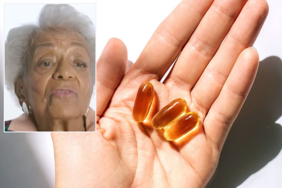 Ida Keeling / Hand holding fish oil supplements