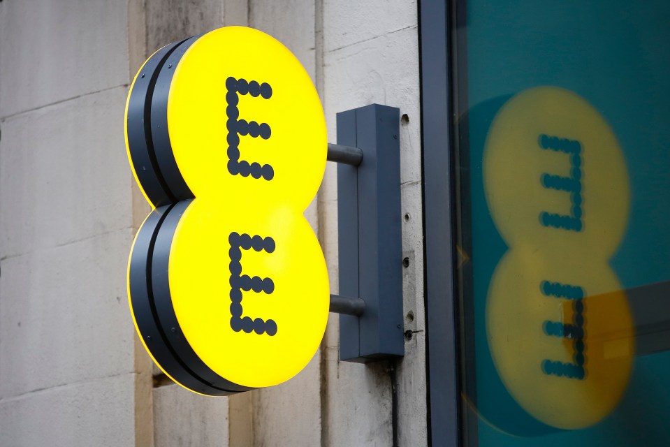 Illuminated EE logo on a building.