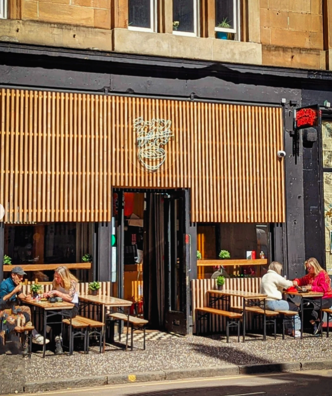 Exterior view of a restaurant with outdoor seating.