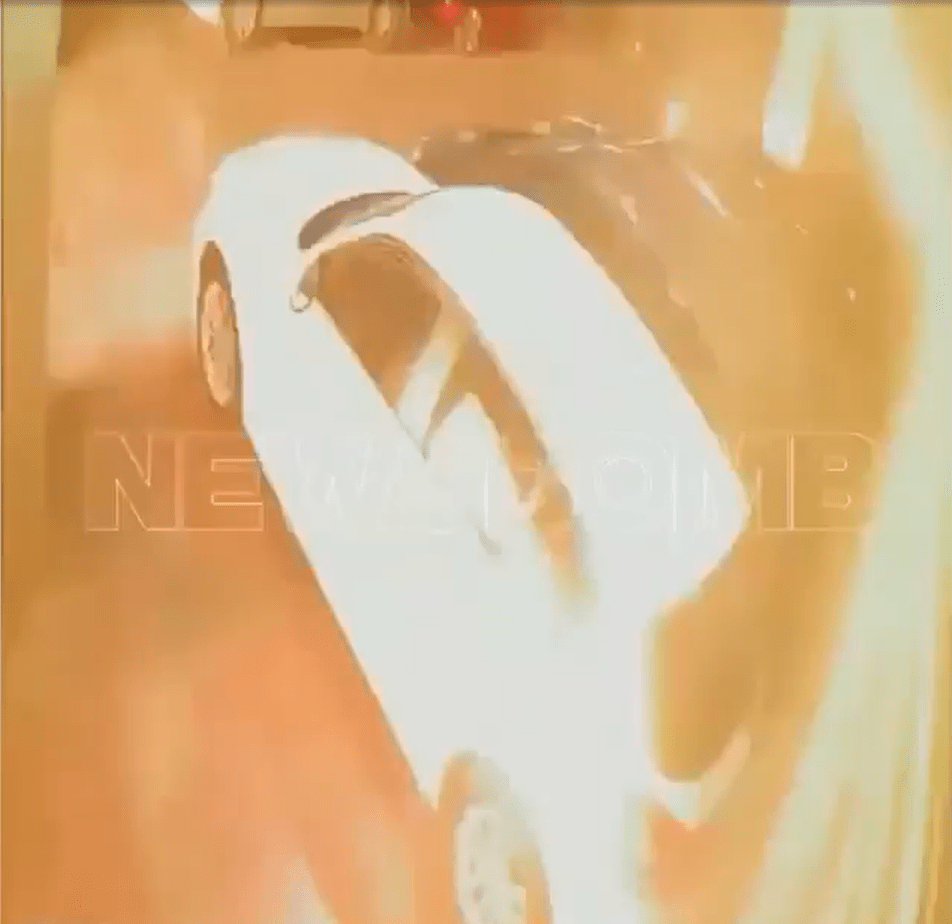 Security camera footage of a white car.