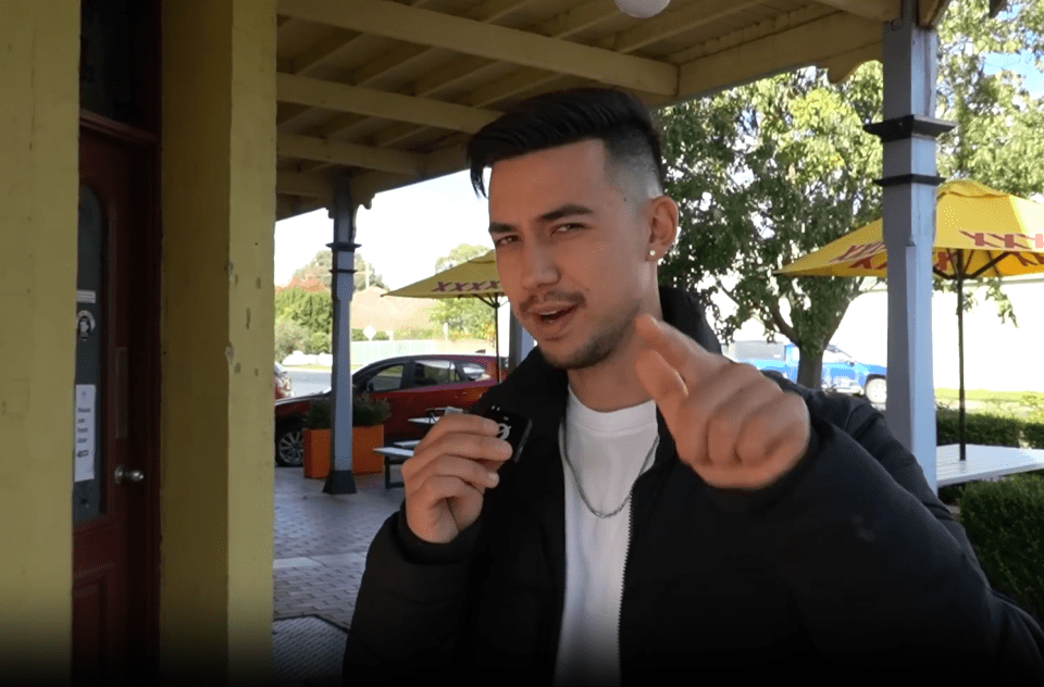 Man holding a small device and pointing.