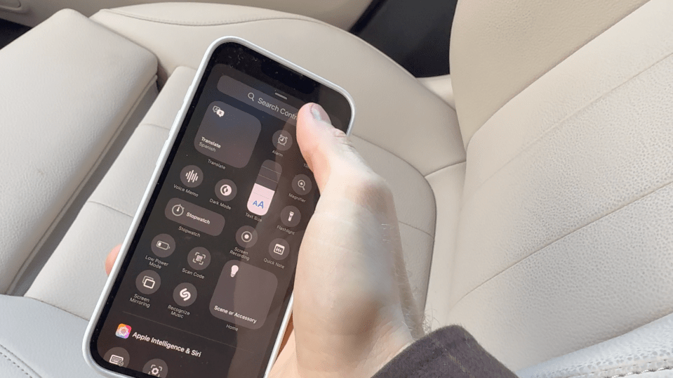 Hand holding iPhone displaying Control Center.