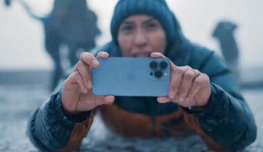A person using an Apple iPhone 13 Pro in Sierra Blue to capture 4K video