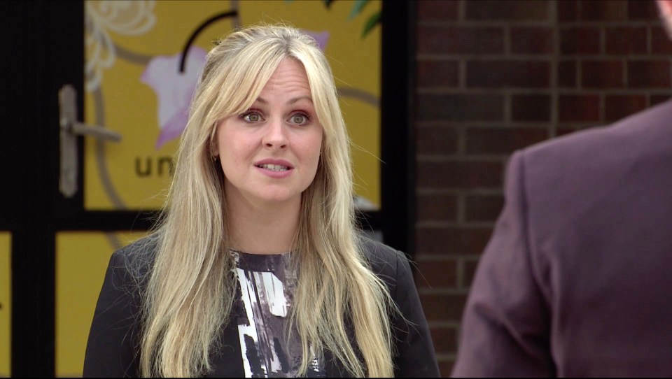 Sarah Platt from Coronation Street yelling at Adam Barlow outside a factory.