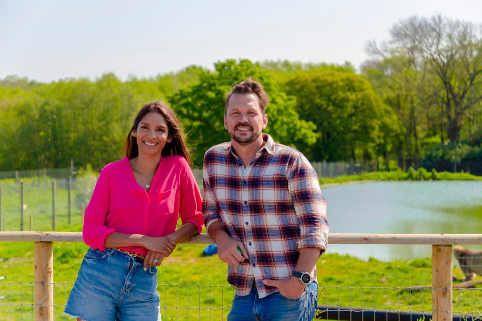 Jimmy and Shivi, hosts of Farmhouse Breakfast, standing by a fence.