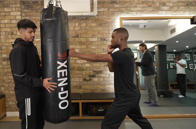 Joshua punching a punchbag