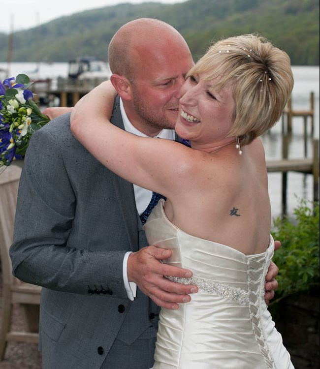 Bride and groom embracing on their wedding day.