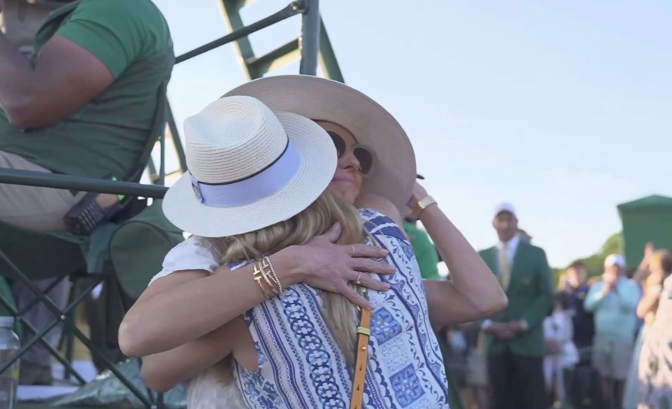 Two women hugging after a golf putt.