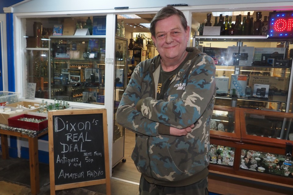 Man standing in his antique and amateur radio shop.