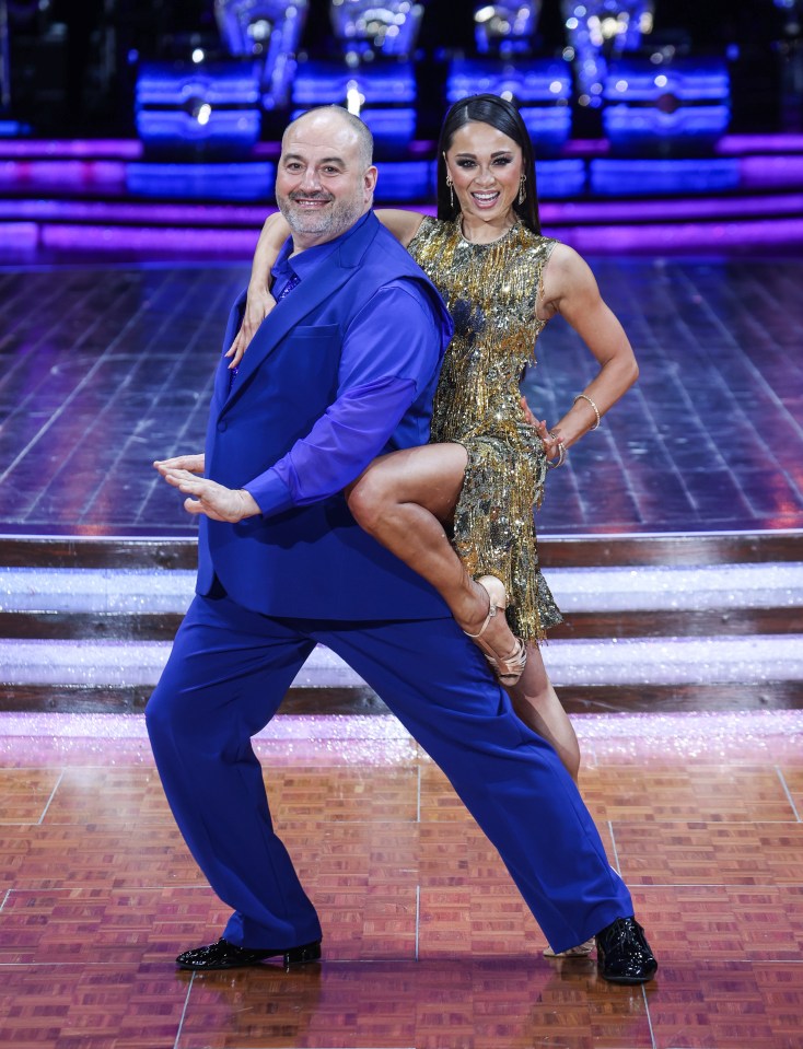 Two dancers posing on a dance floor.