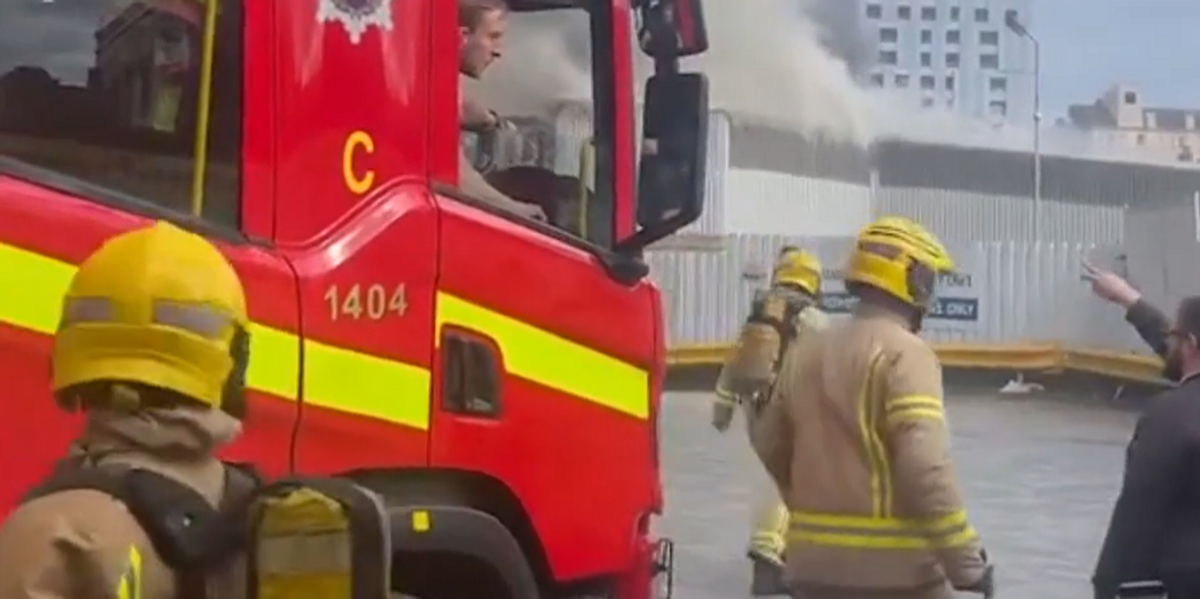 Firefighters evacuate major UK train station and shops evacuated as plumes of smoke spark travel chaos