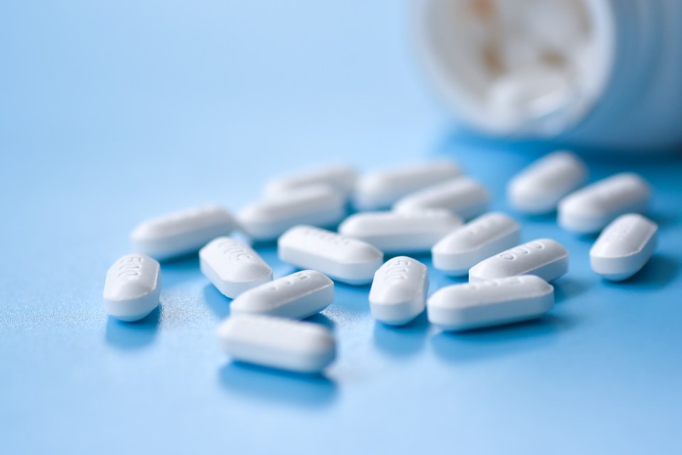 White pills spilled from a bottle.