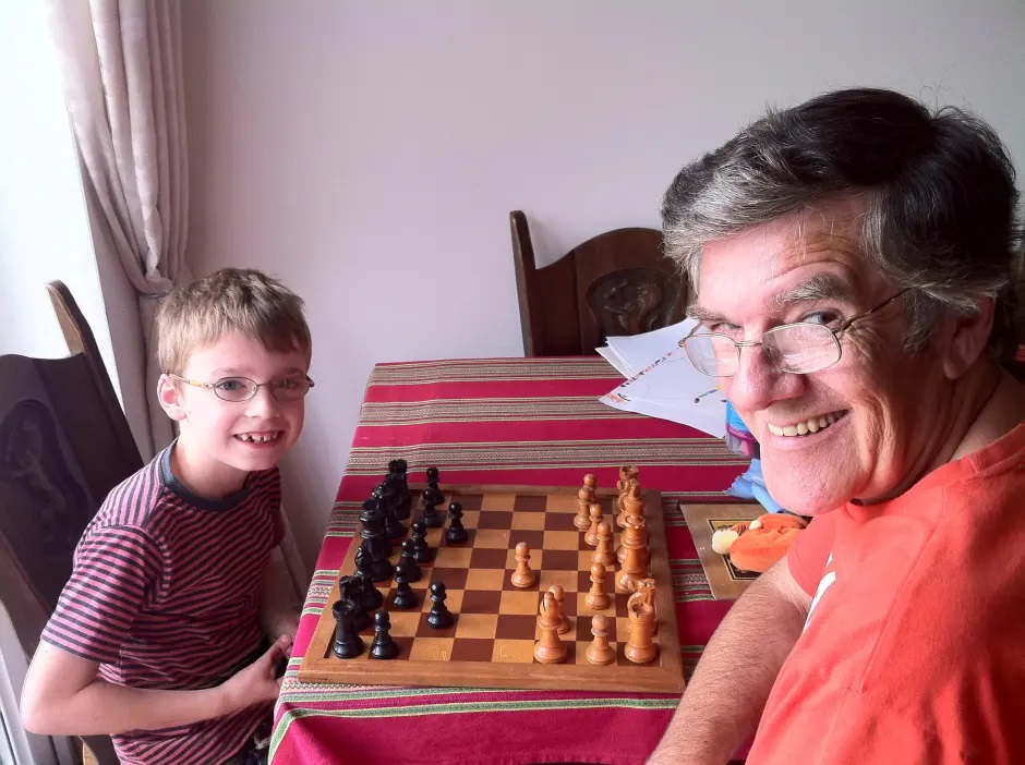 Mick O'Reilly playing chess with his grandson.